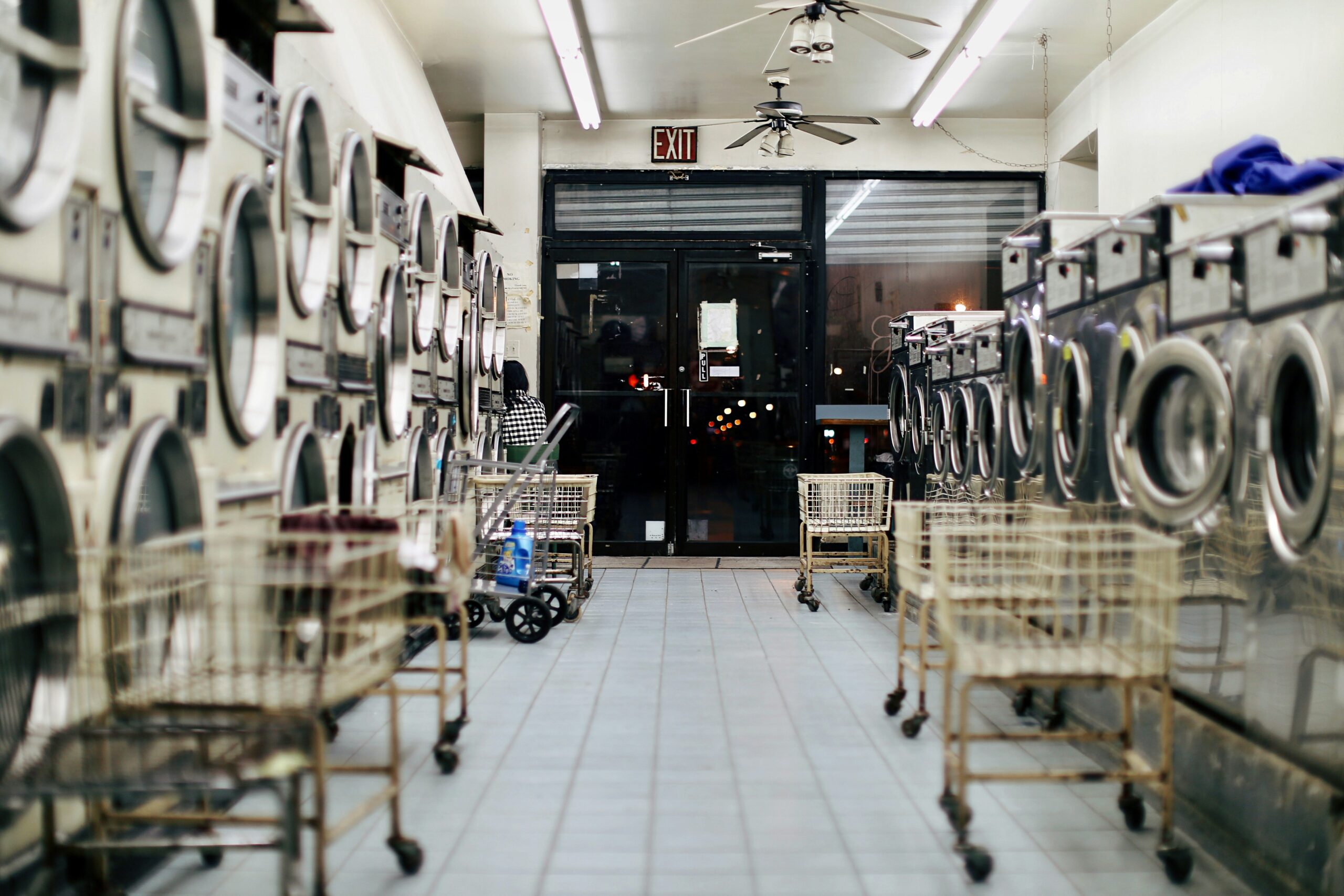 Interior of laundromat with empty shopping carts.